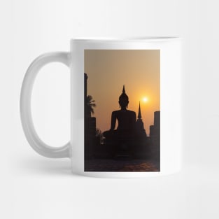 Buddha statue against sunset silhouette Mug